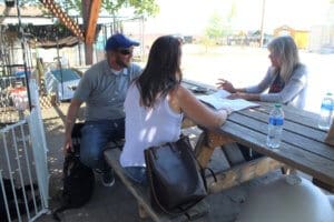 Mary Luton goes over deatils of adoption agreement for Rescue Ranch puppy Iris