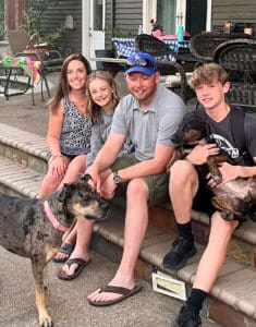 Rescue puppy Iris in her new home with adopters, their children and Bailey her new big sister
