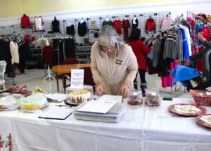 Rescue Ranch Thrift Store interior, Grand opening, Jodi Wilson revieing cake auction