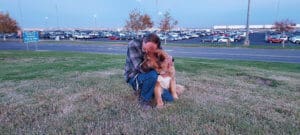 Saint Bernard, Thor, sitting and leaning against Rick on the grass
