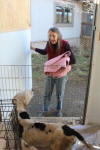 Emaciated dog,Hope,and Laura at the whelping shed door