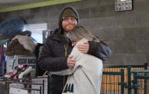 Team member, Ari with hugging Mary at goodbye lunch