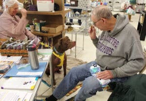 Thrift Store, Bill holding up treat for MIna