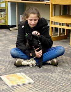 Puppies puppies puppies_Girl sitting on the fllor with puppy in her lap