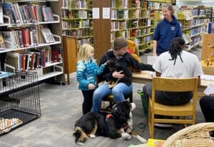 puppy on visitor lap