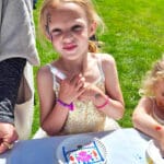 Dog Paw Prints_Kid posing with decorated paper plate