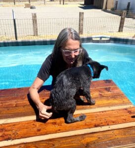 Laura in the pool with recovering Roxy on the float
